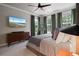 Main bedroom featuring a view of the backyard, a dresser, and a ceiling fan at 1815 La Dawn Nw Ln, Atlanta, GA 30318