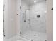 Modern walk-in shower with gray-streaked marble walls and a rain shower head at 1815 La Dawn Nw Ln, Atlanta, GA 30318