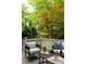 Cozy back deck with comfortable seating amid lush trees and a leafy backyard at 230 Milton Se Ave, Atlanta, GA 30315