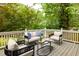Cozy back deck with comfortable seating surrounded by lush trees at 230 Milton Se Ave, Atlanta, GA 30315