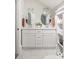 Bright bathroom featuring double sinks, updated cabinetry, and modern tile flooring at 230 Milton Se Ave, Atlanta, GA 30315