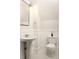 Charming bathroom features a pedestal sink, hexagon tile floor, and classic wainscoting at 230 Milton Se Ave, Atlanta, GA 30315