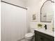 Bathroom featuring a shower with white tile and a vanity with dark green cabinets at 230 Milton Se Ave, Atlanta, GA 30315