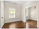 Bedroom showing wood floors, large window, and open doorway at 230 Milton Se Ave, Atlanta, GA 30315