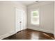 Bedroom featuring hardwood floors, a window with blinds, and a closet at 230 Milton Se Ave, Atlanta, GA 30315