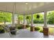 Inviting front porch with a porch swing, plants, and white columns at 230 Milton Se Ave, Atlanta, GA 30315