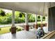 Inviting front porch with a porch swing, ferns, and white columns at 230 Milton Se Ave, Atlanta, GA 30315