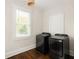 Bright laundry room features modern washer and dryer set, window, and wooden floors at 230 Milton Se Ave, Atlanta, GA 30315