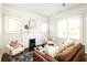 Cozy living room with hardwood floors, a fireplace, and ample natural light at 230 Milton Se Ave, Atlanta, GA 30315