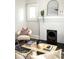 Bright living room features a fireplace, decor, hardwood floors and lots of light at 230 Milton Se Ave, Atlanta, GA 30315