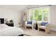 Cozy main bedroom sitting area with bright window, neutral chairs, and stylish decor at 230 Milton Se Ave, Atlanta, GA 30315