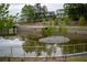 Picturesque pond with a central island and pedestrian bridge, enhancing the community's natural beauty at 230 Milton Se Ave, Atlanta, GA 30315