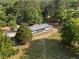 Aerial view showcases the home nestled among mature trees on a large, beautifully landscaped lot at 2604 Flat Shoals Sw Rd, Conyers, GA 30094