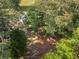 Aerial view of a house nestled among mature trees offering privacy and shade at 2604 Flat Shoals Sw Rd, Conyers, GA 30094