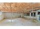 Unfinished basement with exposed insulation, concrete walls, metal support posts, and utility hookups at 2604 Flat Shoals Sw Rd, Conyers, GA 30094