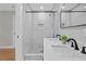 A modern bathroom featuring double sinks, quartz countertops, a tiled shower, and mosaic tile flooring at 2604 Flat Shoals Sw Rd, Conyers, GA 30094