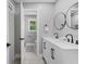Well-lit bathroom with dual vanity, framed round mirrors, and modern fixtures, perfect for a contemporary aesthetic at 2604 Flat Shoals Sw Rd, Conyers, GA 30094