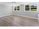 Bright and airy bedroom with wood grain flooring and large windows overlooking the yard at 2604 Flat Shoals Sw Rd, Conyers, GA 30094