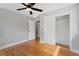 Comfortable bedroom featuring hardwood floors, ceiling fan, and a closet for storage at 2604 Flat Shoals Sw Rd, Conyers, GA 30094