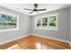 Well-lit bedroom features hardwood floors and large windows that offer a view of the outdoors at 2604 Flat Shoals Sw Rd, Conyers, GA 30094