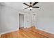 Comfortable bedroom with hardwood floors, ceiling fan, and a spacious closet for ample storage at 2604 Flat Shoals Sw Rd, Conyers, GA 30094