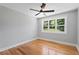 Cozy bedroom with hardwood floors, ceiling fan, and window offering a pleasant view of the outdoors at 2604 Flat Shoals Sw Rd, Conyers, GA 30094