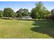 Spacious property with a lush green lawn and mature trees surrounding the home at 2604 Flat Shoals Sw Rd, Conyers, GA 30094