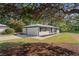 Charming property with a well-manicured lawn and a detached garage, surrounded by mature trees at 2604 Flat Shoals Sw Rd, Conyers, GA 30094
