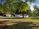 Picturesque home featuring a detached garage, mature trees, and a well-maintained lawn at 2604 Flat Shoals Sw Rd, Conyers, GA 30094