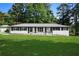 Beautifully renovated home with black shutters, white paint, and a well-maintained lawn at 2604 Flat Shoals Sw Rd, Conyers, GA 30094