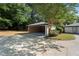 Detached garage and driveway offer ample parking space and convenient access to the home at 2604 Flat Shoals Sw Rd, Conyers, GA 30094