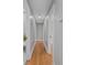 Bright hallway with hardwood floors leads to various rooms, offering a seamless transition between spaces at 2604 Flat Shoals Sw Rd, Conyers, GA 30094