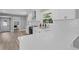 A modern kitchen featuring white cabinets, stainless steel appliances, and a large quartz countertop at 2604 Flat Shoals Sw Rd, Conyers, GA 30094