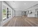 Bright and open living room featuring light wood floors, neutral walls, and large windows at 2604 Flat Shoals Sw Rd, Conyers, GA 30094