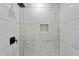 Modern shower with unique tile design, dark hardware and built-in niche for added convenience at 2604 Flat Shoals Sw Rd, Conyers, GA 30094