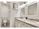 Bathroom featuring dual sinks, granite countertop, and neutral tile at 4679 Glenshire Pl, Atlanta, GA 30338