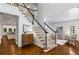Inviting foyer with hardwood floors, a staircase with white spindles, and views into the living spaces at 4679 Glenshire Pl, Atlanta, GA 30338