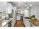 Updated kitchen with stainless steel appliances, white cabinetry, and granite countertops at 4679 Glenshire Pl, Atlanta, GA 30338