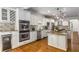 Spacious kitchen with white cabinets, granite countertops, stainless steel appliances, and hardwood floors at 4679 Glenshire Pl, Atlanta, GA 30338