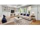 Bright, open living room featuring built-in shelving, hardwood floors, and a neutral color palette at 4679 Glenshire Pl, Atlanta, GA 30338