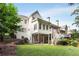 Two-story home showcasing the rear exterior with a well-manicured lawn and multi-level deck at 4679 Glenshire Pl, Atlanta, GA 30338