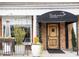 A charming Italian restaurant entrance with rustic wooden door and attractive planters at 4679 Glenshire Pl, Atlanta, GA 30338