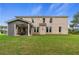 Expansive two-story brick home featuring a covered patio, pristine lawn, and beautiful landscaping at 81 Homesite Hartsfield Rd, Mcdonough, GA 30253