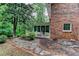 Charming backyard featuring a screened-in porch, brick exterior, and stone walkway at 3539 Evans Mill Rd, Lithonia, GA 30038