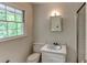 Cozy bathroom featuring a classic vanity, toilet, and shower with natural light at 3539 Evans Mill Rd, Lithonia, GA 30038