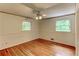 Bedroom with hardwood floors and two windows offering natural light at 3539 Evans Mill Rd, Lithonia, GA 30038