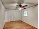 Bedroom with hardwood floors, ceiling fan, and closet space at 3539 Evans Mill Rd, Lithonia, GA 30038