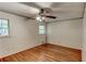 Bedroom with hardwood floors, ceiling fan, and natural light at 3539 Evans Mill Rd, Lithonia, GA 30038