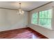 Charming dining room featuring a classic chandelier, natural lighting, and hardwood floors at 3539 Evans Mill Rd, Lithonia, GA 30038