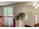 Inviting foyer with elegant light fixture and a view to a living space with a large bay window at 3539 Evans Mill Rd, Lithonia, GA 30038